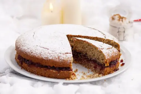 Torta di grano saraceno con marmellata, spolverata di zucchero a velo, su un letto di neve.