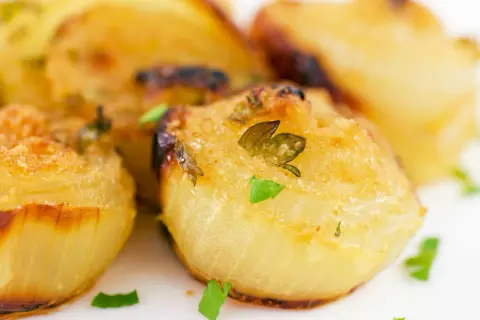 Cipolla al forno intera, dorata e profumata, con erbe aromatiche fresche. Un contorno semplice e gustoso.