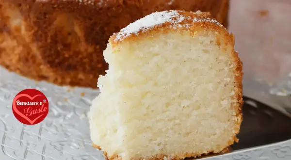 Una fetta di torta senza glutine, soffice e dorata, cosparsa di zucchero a velo. Un piacere per il palato e per il benessere.