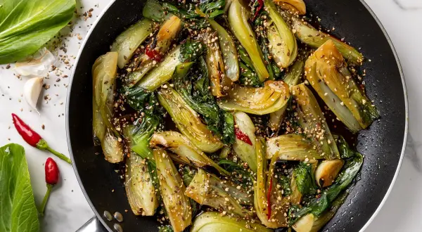Pak choi saltato in padella con aglio, peperoncino e semi di sesamo. Un'idea veloce per gustose ricette in padella.