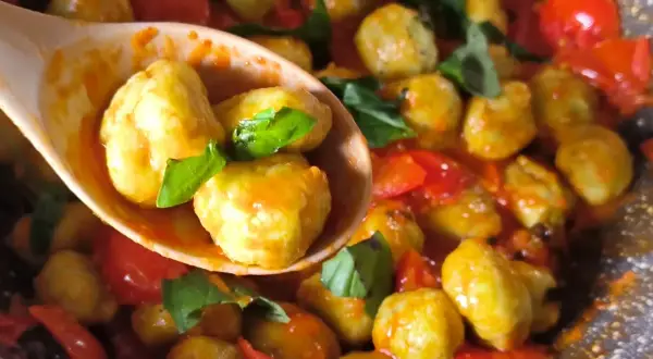 Gnocchi di zucchine succulenti in padella con pomodorini e basilico fresco. Un piatto leggero e saporito.